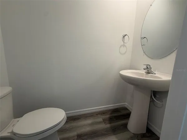 a bathroom with a sink toilet and a mirror