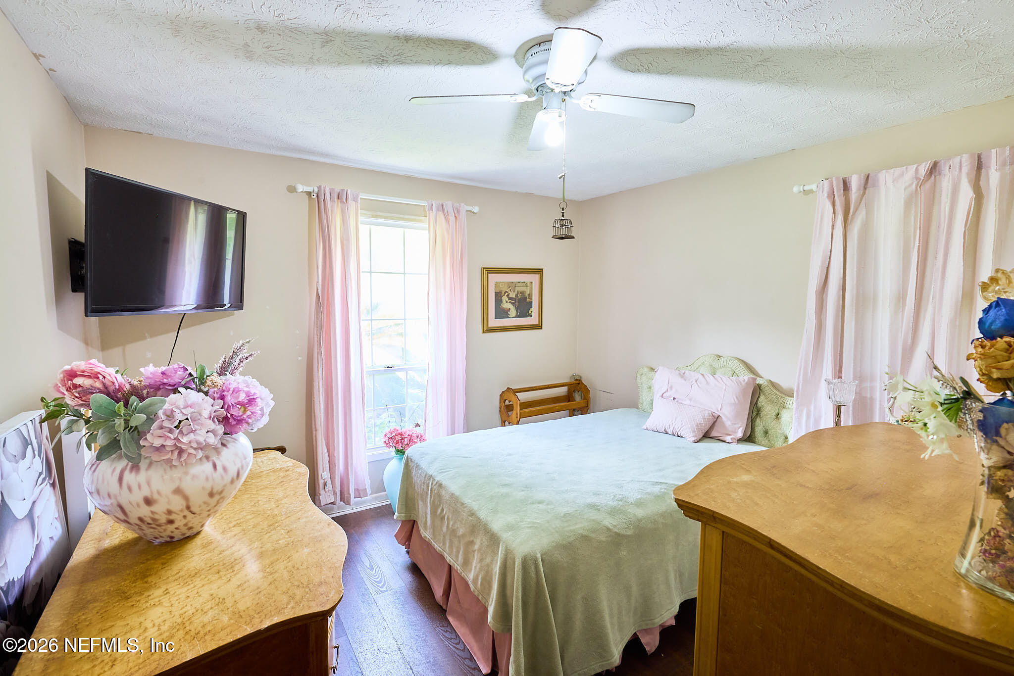 8965 San Rae Road Jacksonville, FL 32257 - Photo 12 of 46 a bedroom with a bed and a chandelier