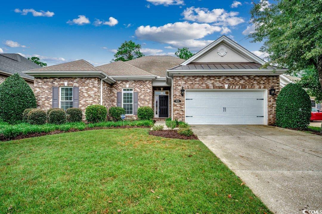 Ranch-style house with brick siding, driveway, a front yard, a garage, and roof with shingles