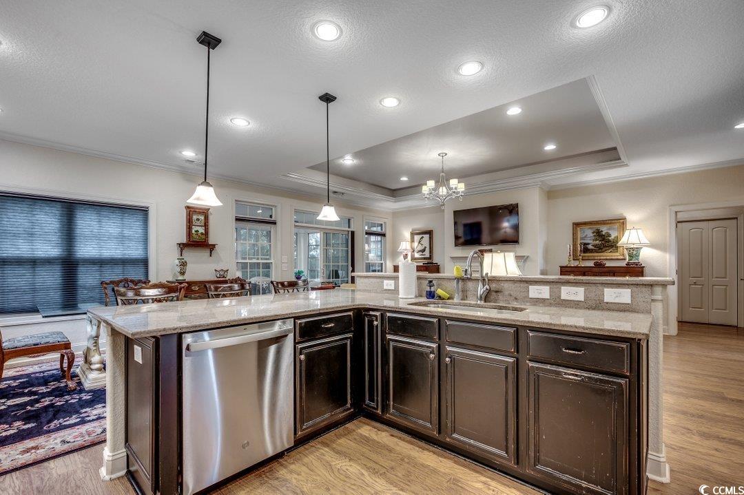 908 Corrado Street Myrtle Beach, SC 29572 - Photo 33 of 33 Kitchen featuring a tray ceiling, stainless steel dishwasher, open floor plan, light wood-type flooring, and crown molding