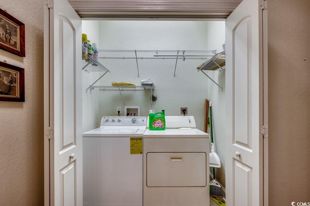 908 Corrado Street Myrtle Beach, SC 29572 - Photo 18 of 33 Laundry area with a textured wall and washing machine and clothes dryer