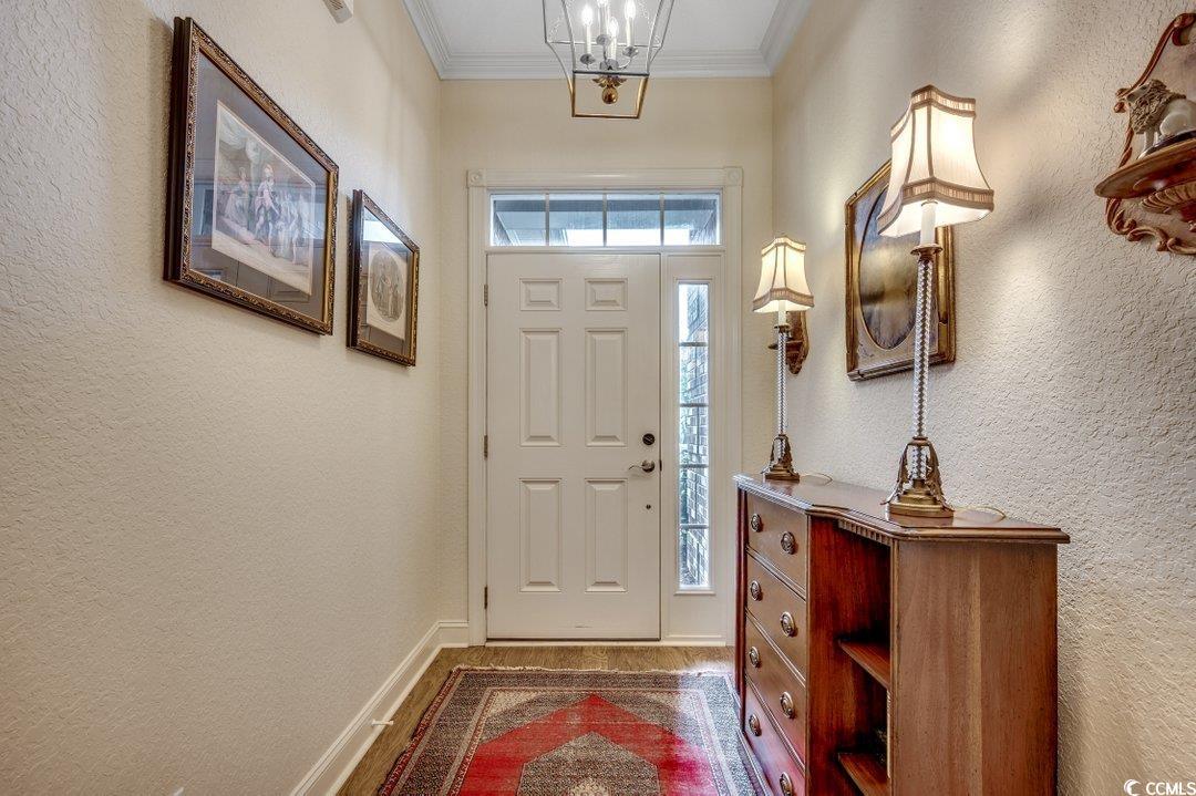 908 Corrado Street Myrtle Beach, SC 29572 - Photo 22 of 33 Foyer featuring a textured wall, ornamental molding, and a chandelier