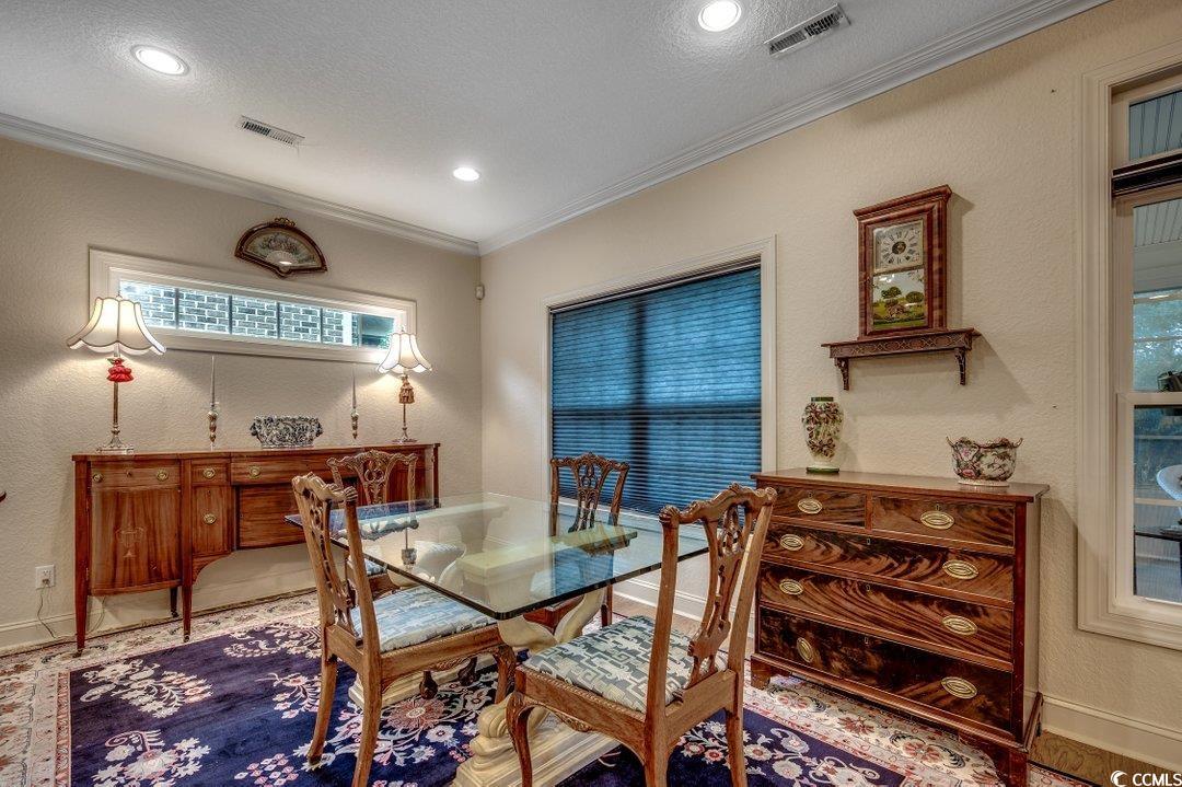 908 Corrado Street Myrtle Beach, SC 29572 - Photo 6 of 33 Dining room with a textured wall, crown molding, a textured ceiling, and recessed lighting