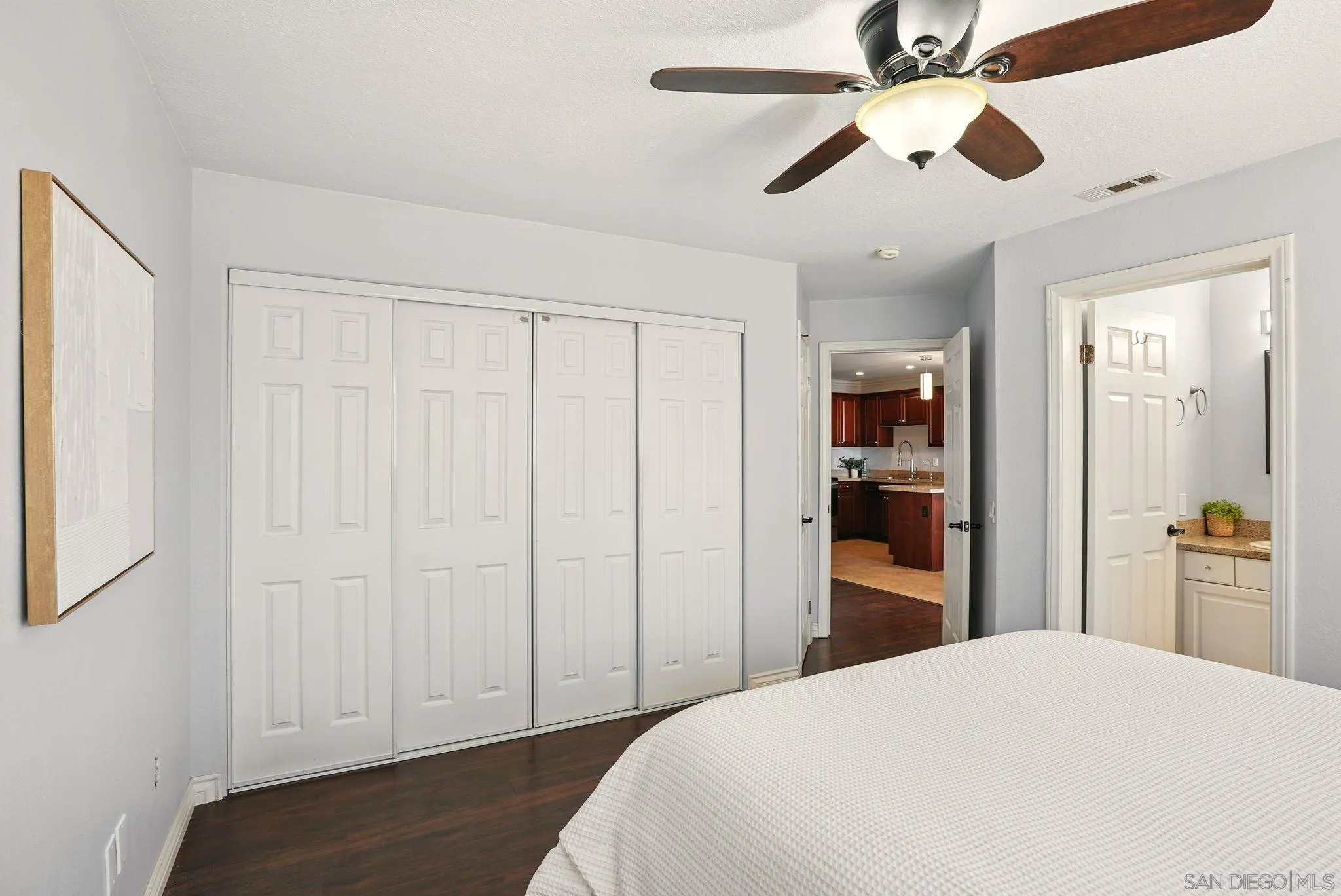 3545 Paseo De Francisco, Unit 231 Oceanside, CA 92056 - Photo 16 of 50 a bedroom with a bed and a chandelier