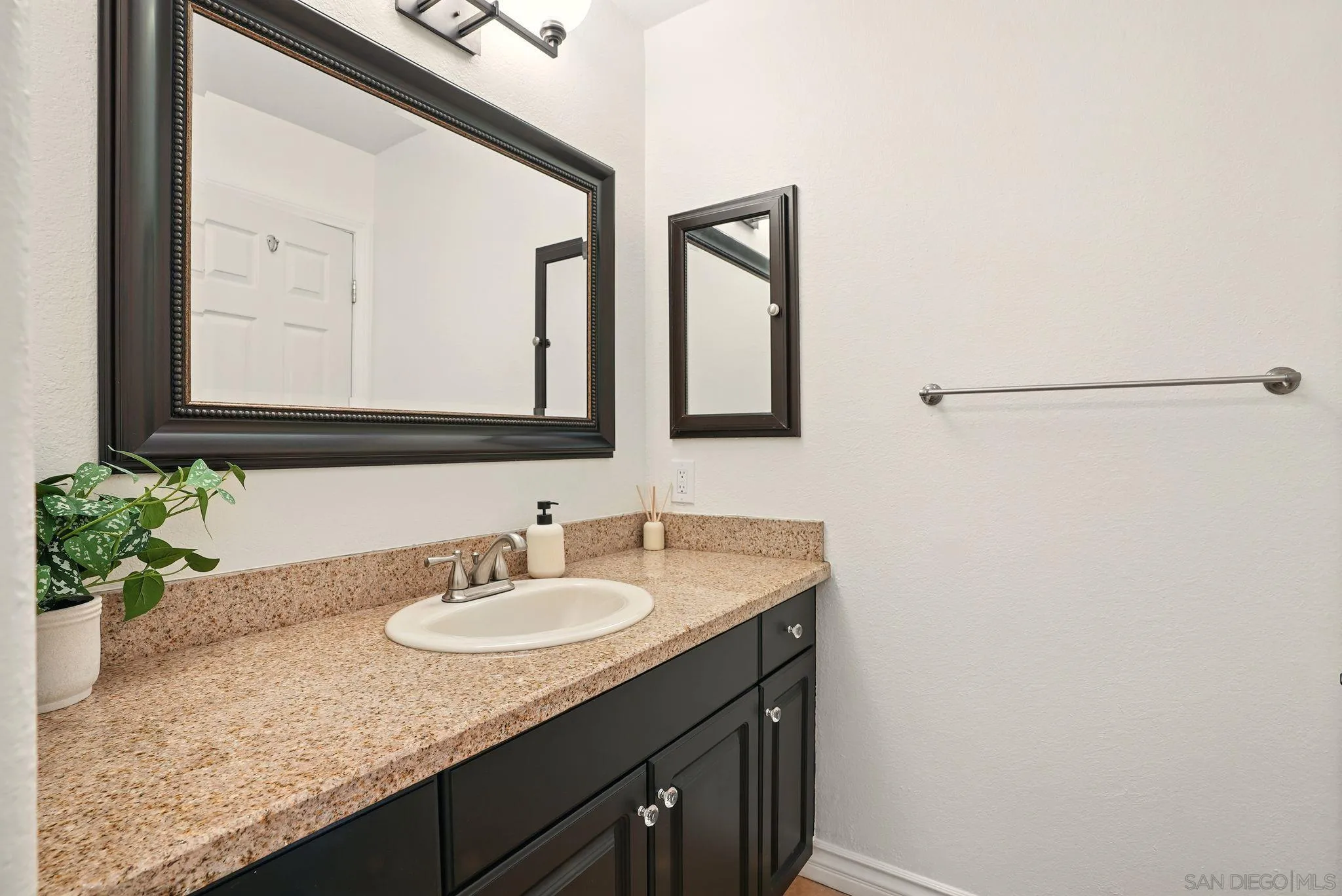 3545 Paseo De Francisco, Unit 231 Oceanside, CA 92056 - Photo 21 of 50 a bathroom with a granite countertop sink and a mirror