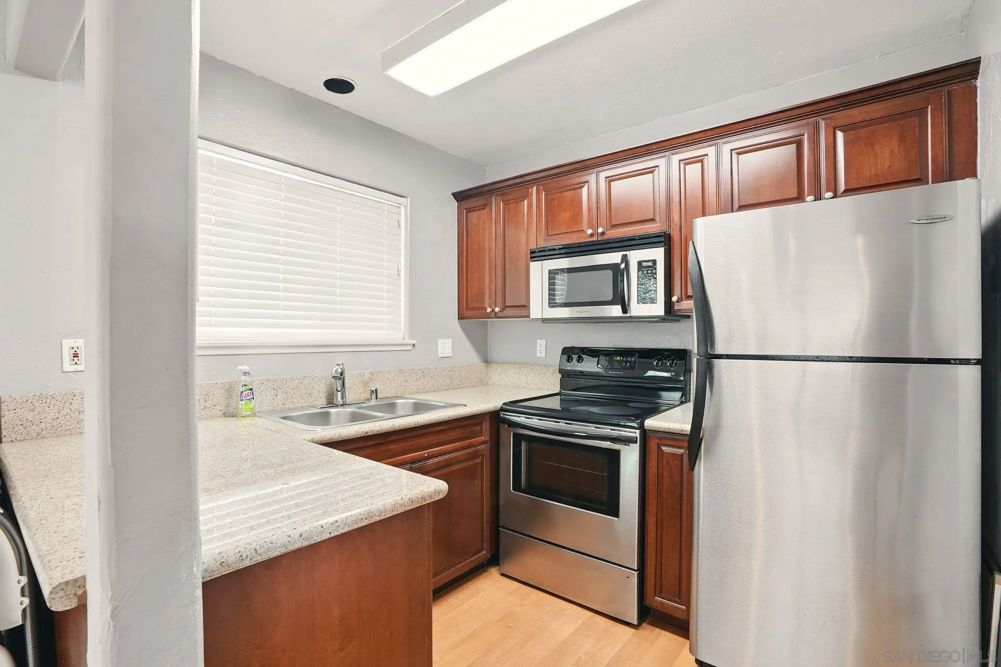 3545 Paseo De Francisco, Unit 231 Oceanside, CA 92056 - Photo 41 of 50 a kitchen with stainless steel appliances granite countertop a sink stove and refrigerator