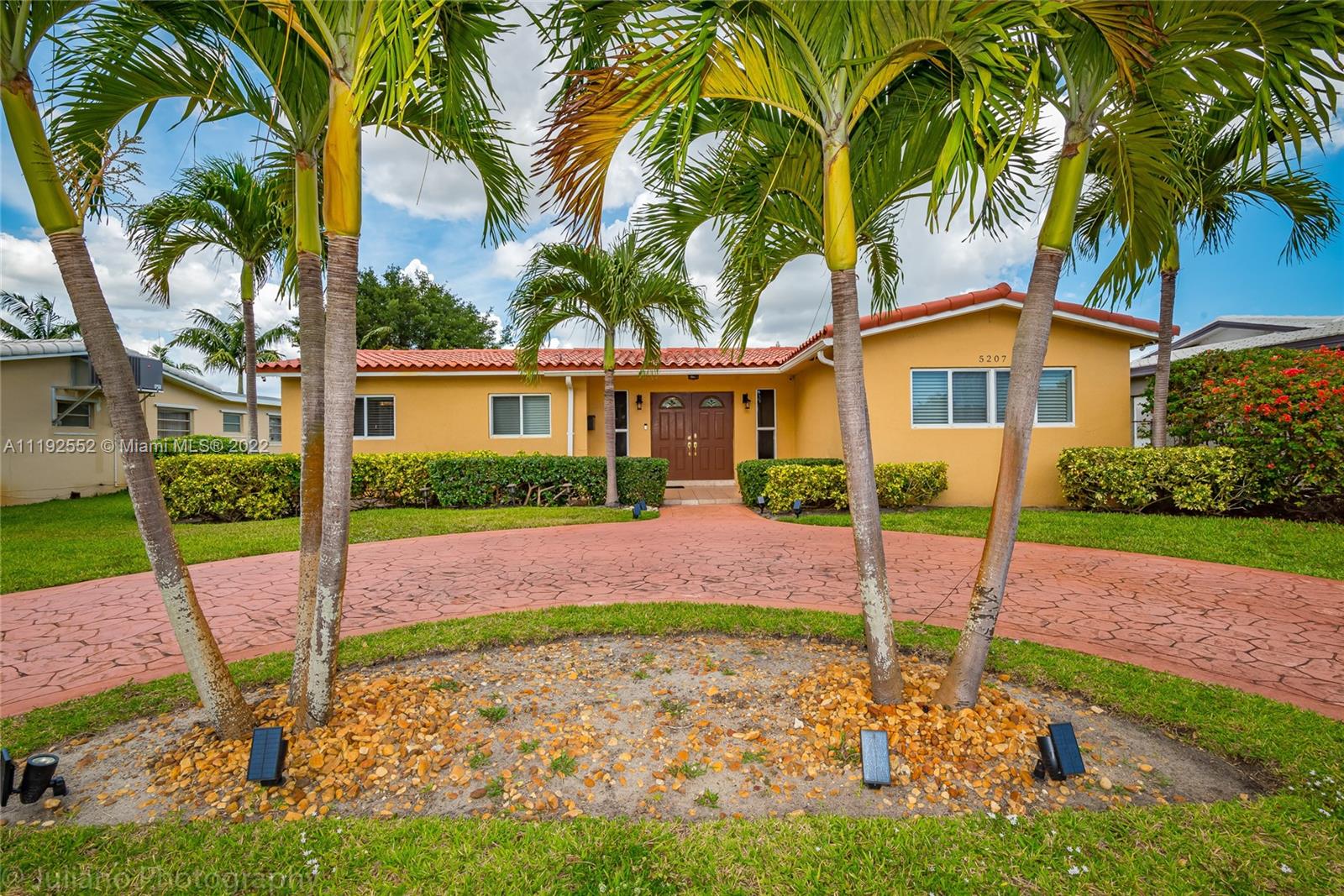 a view of a house with a yard and tree s