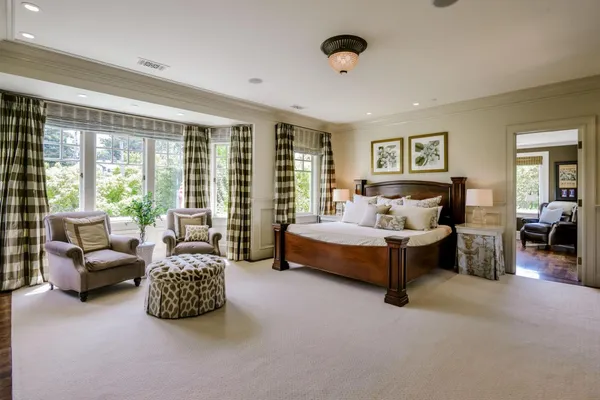 a bedroom with furniture and a large window
