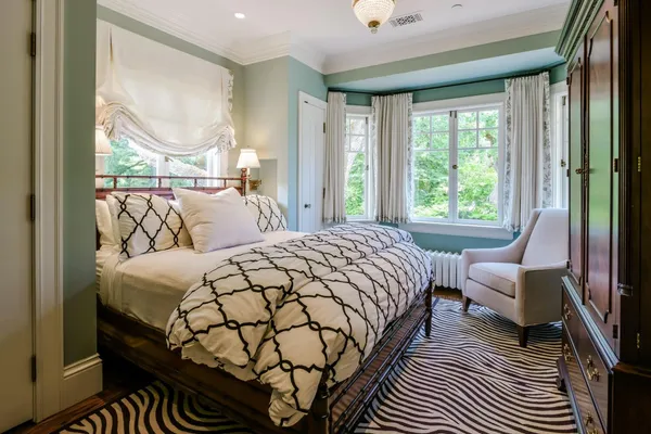 a bedroom with a large bed and a window