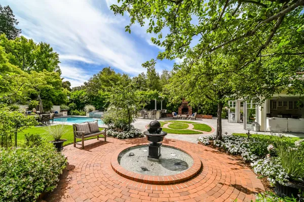 a view of a backyard with swimming pool