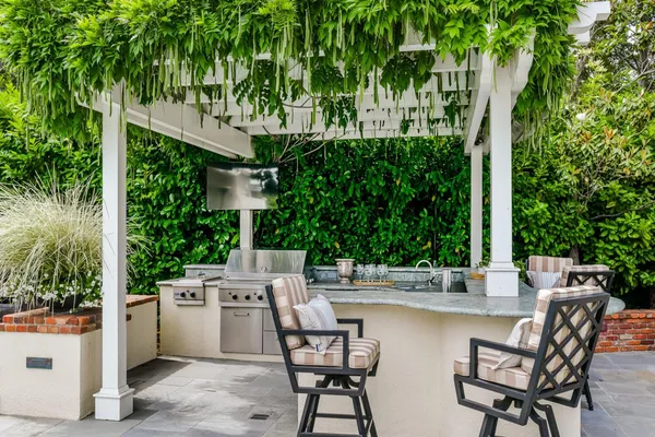 a view of a patio with table and chairs and potted plants