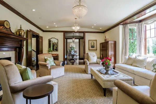 a living room with furniture potted plant and a large window