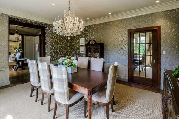 a view of a dining room with furniture and chandelier