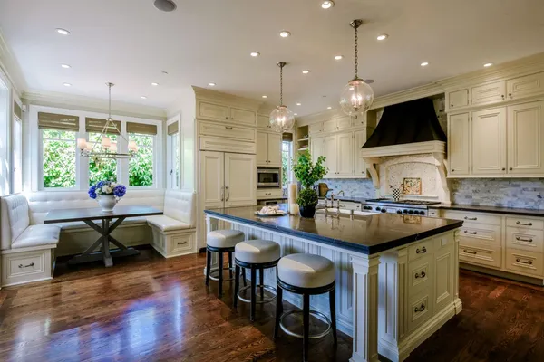 a kitchen with counter space sink stove and furniture