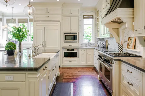 a kitchen with stainless steel appliances granite countertop a stove a sink and a refrigerator