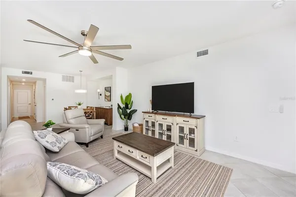 a spacious bedroom with a large bed and a chandelier