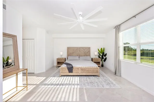 a bedroom with a bed a dresser and a window