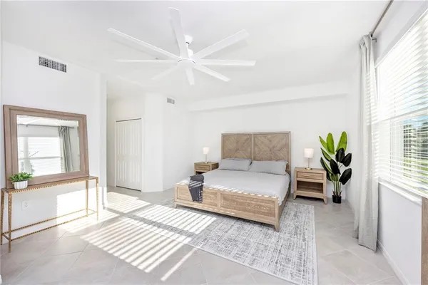 a bedroom with a bed and a night stand