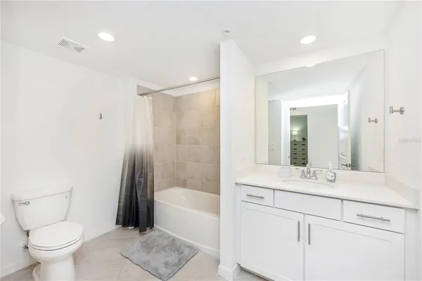 a swimming pool view with a seating space and a garden view