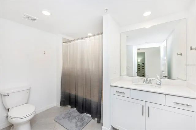 a front view of a house with glass windows and furniture