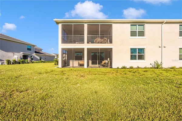 a view of a house with backyard porch and sitting area