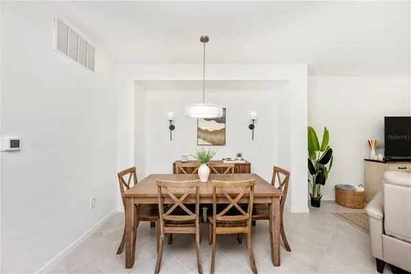a kitchen with appliances a sink a counter top space and living room view