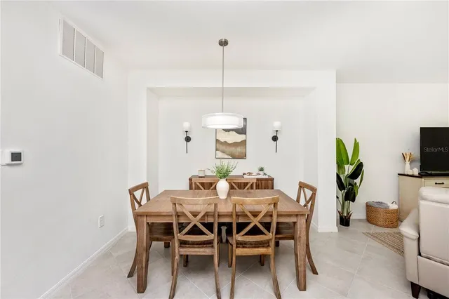 a kitchen with appliances a sink a counter top space and living room view