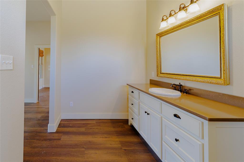 1433 County Road 1180 Decatur, TX 76234 - Photo 18 of 36 a bathroom with a sink and a mirror