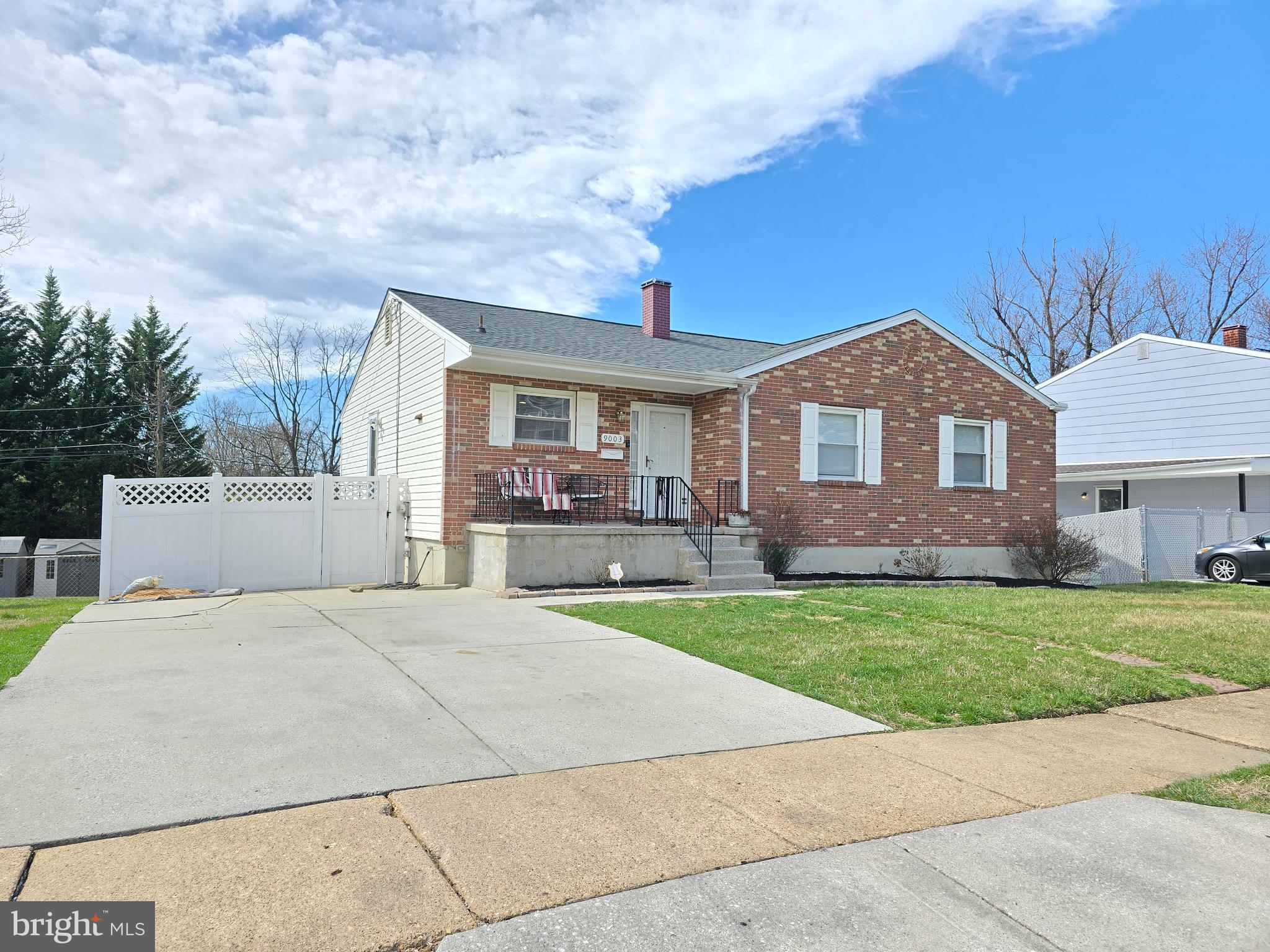 a front view of a house with a garden and yard