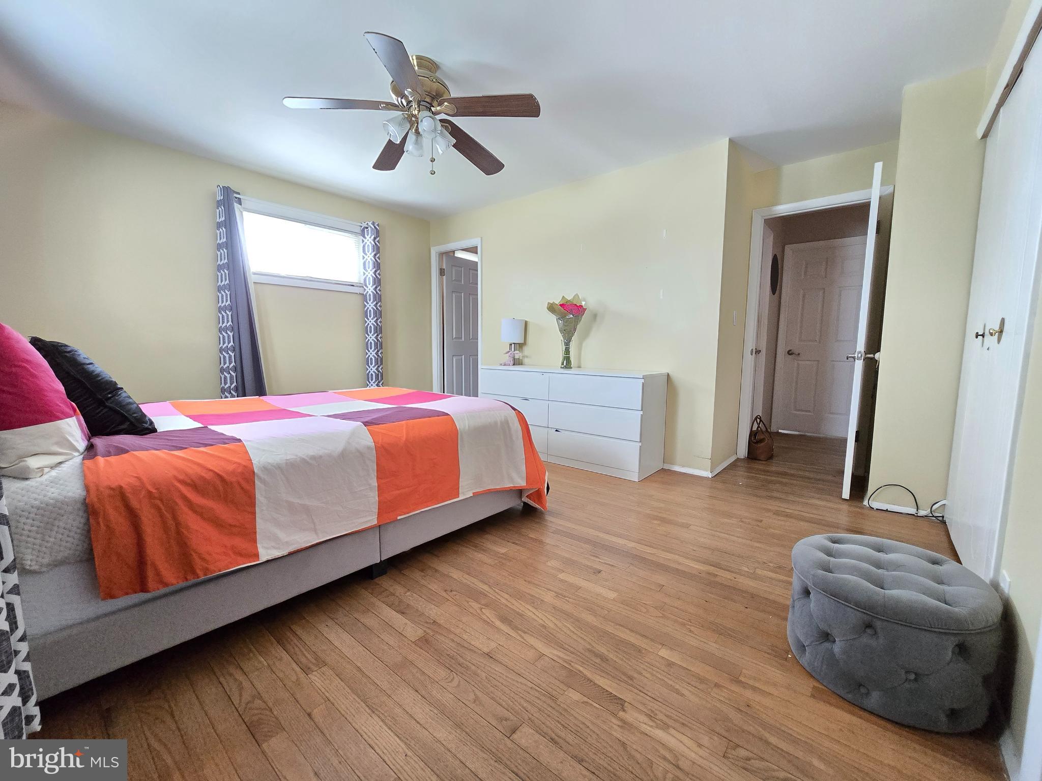 9003 Bruno Road Randallstown, MD 21133 - Photo 14 of 25 a bedroom with a bed and dresser with wooden floor