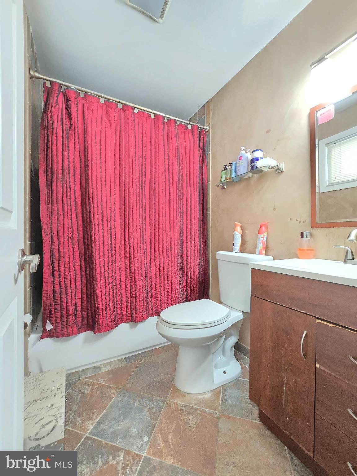 9003 Bruno Road Randallstown, MD 21133 - Photo 15 of 25 a bathroom with a toilet a sink and curtain