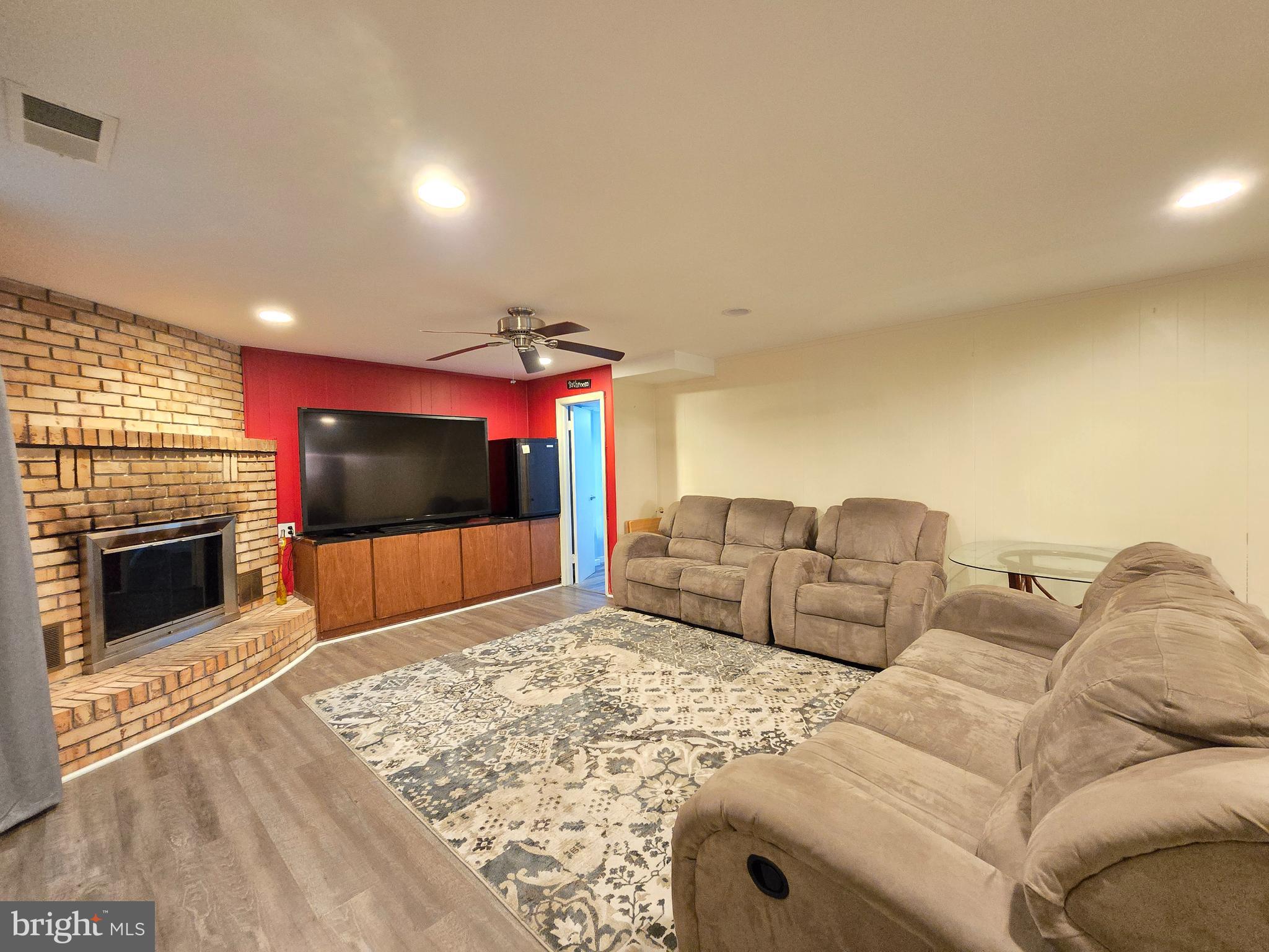 9003 Bruno Road Randallstown, MD 21133 - Photo 18 of 25 a living room with furniture a flat screen tv and a fireplace
