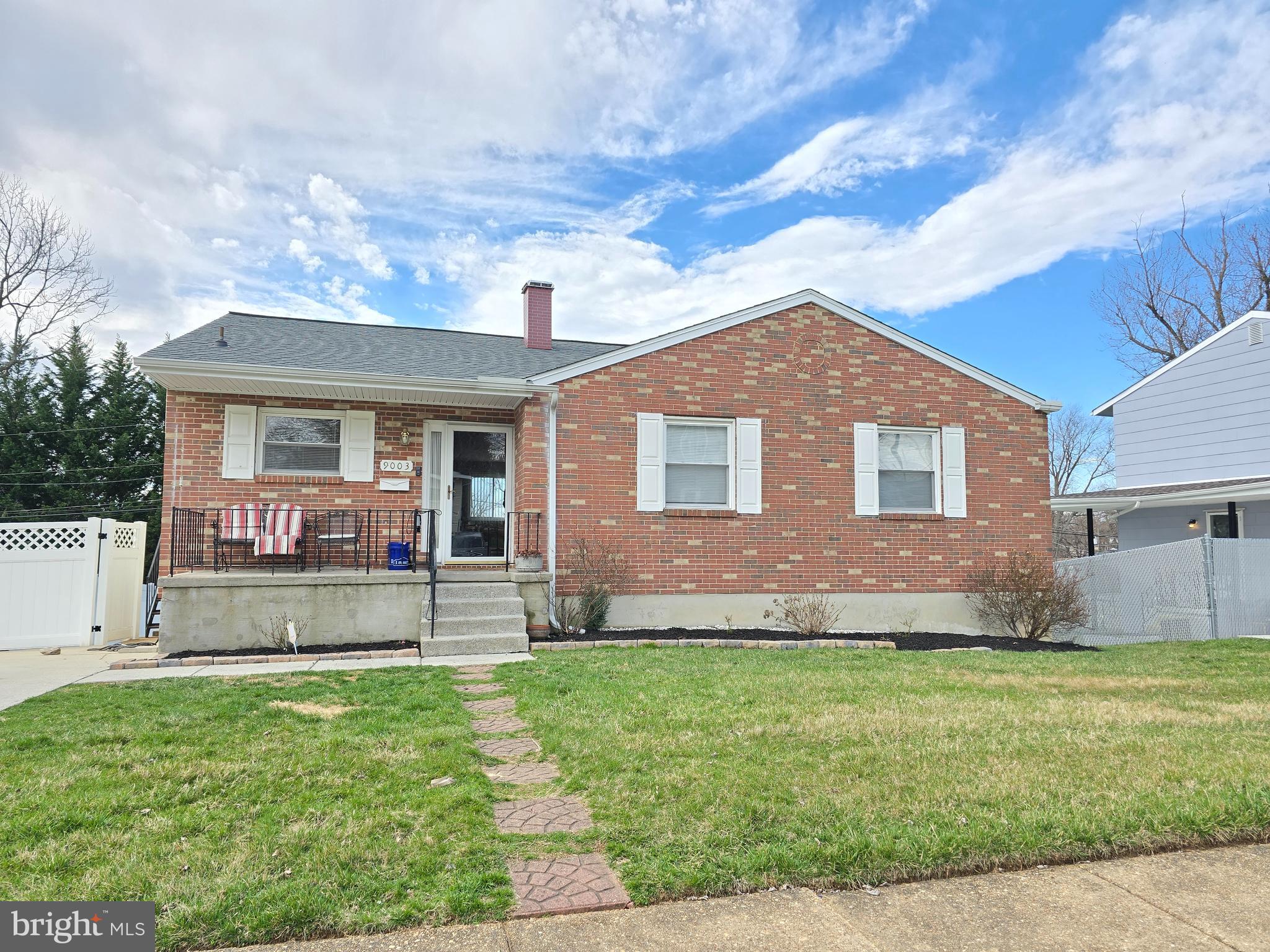 9003 Bruno Road Randallstown, MD 21133 - Photo 2 of 25 a front view of a house with a yard and garage