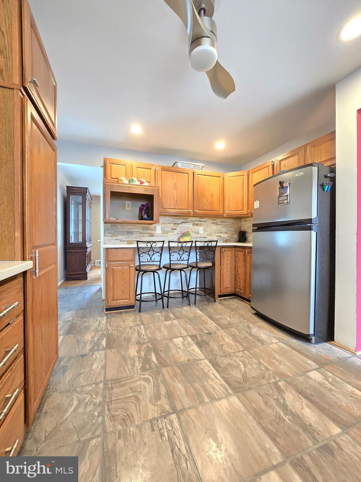 9003 Bruno Road Randallstown, MD 21133 - Photo 8 of 25 a kitchen with stainless steel appliances granite countertop a refrigerator and a stove top oven