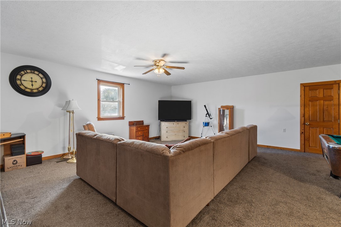 29395 Beitler Road Dennison, OH 44621 - Photo 27 of 33 Carpeted living room with a ceiling fan, billiards, and a textured ceiling