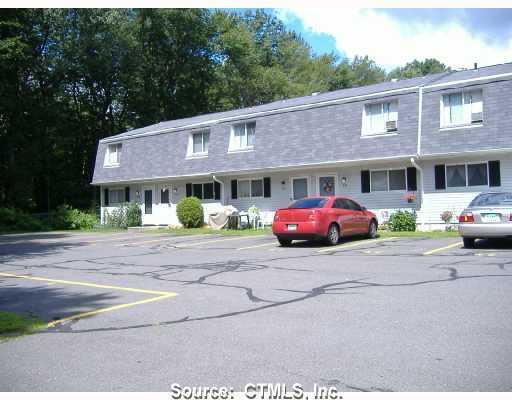 1568 Meriden Road, Unit 8J Waterbury, CT 06705 - Photo 1 of 1 a front view of a building with cars parked