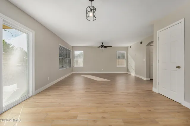 a view of a livingroom with wooden floor and a window
