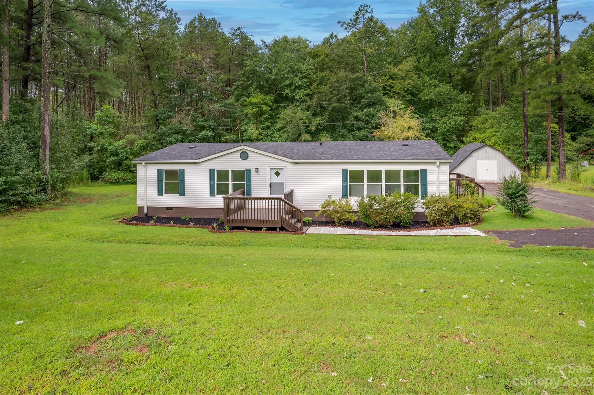 481 Brooks Road Bostic, NC 28018 - Photo 1 of 28 a front view of a house with a garden