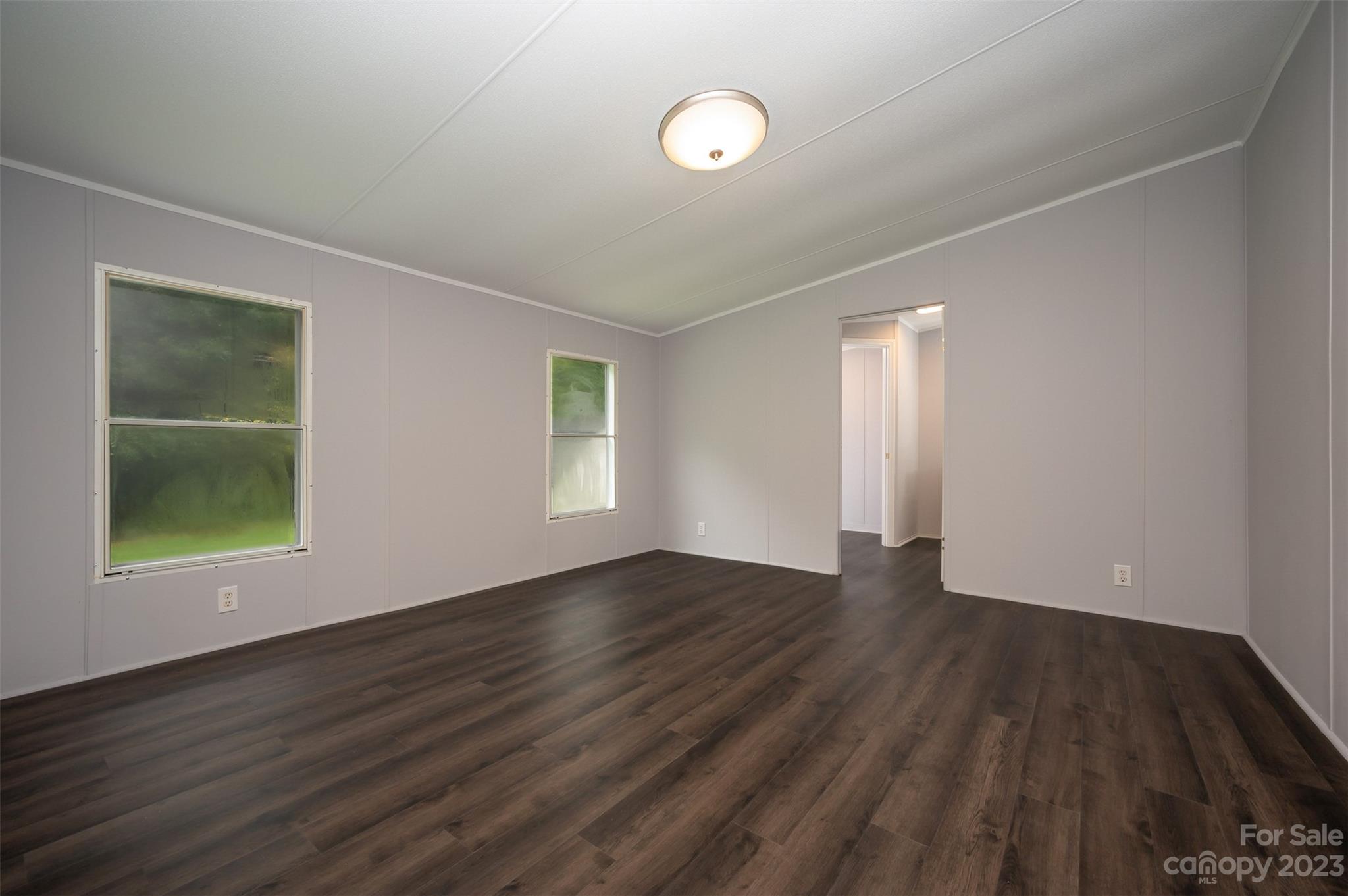 481 Brooks Road Bostic, NC 28018 - Photo 11 of 28 an empty room with wooden floor and windows