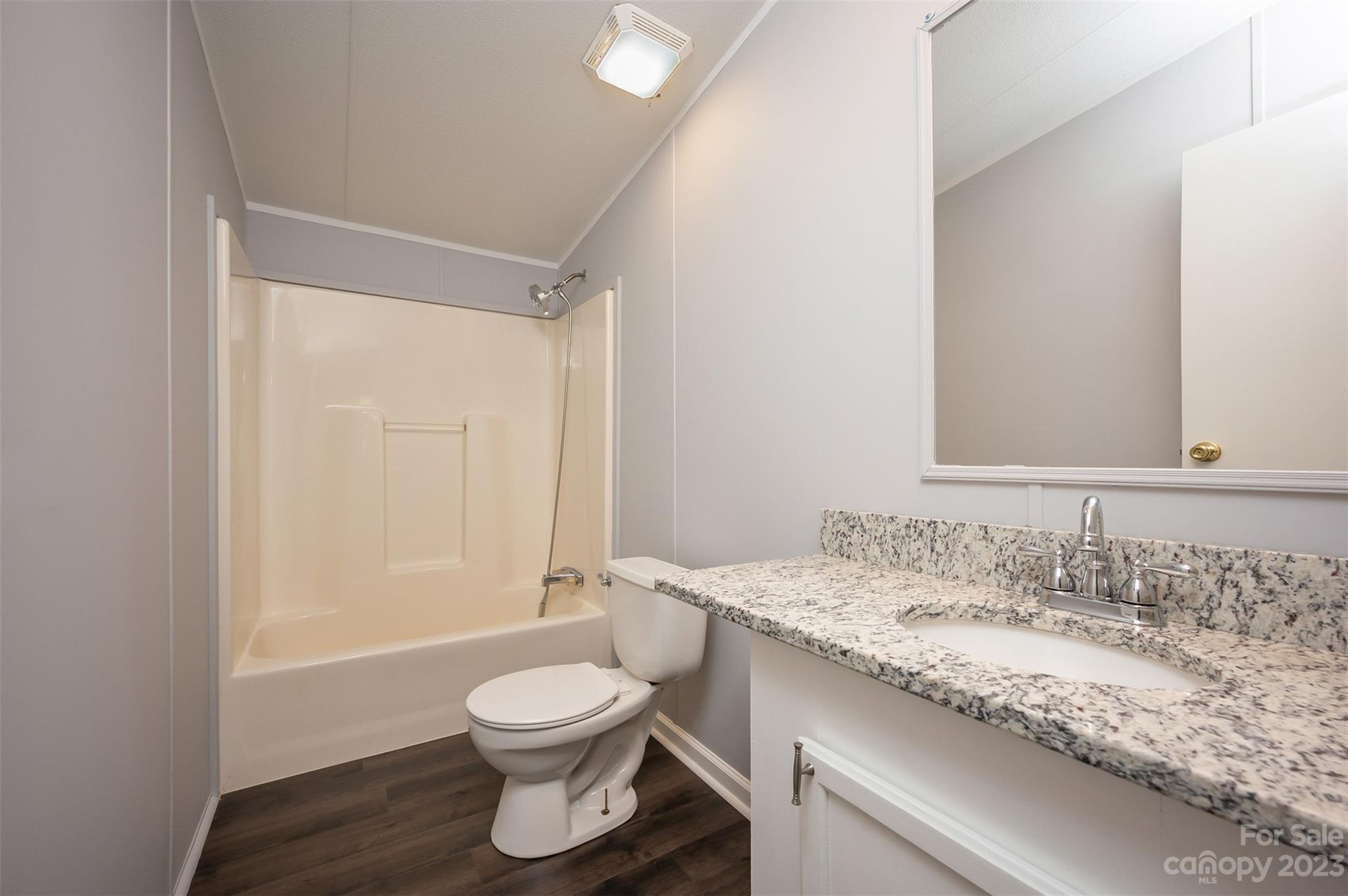 481 Brooks Road Bostic, NC 28018 - Photo 15 of 28 a bathroom with a granite countertop sink toilet a mirror and shower
