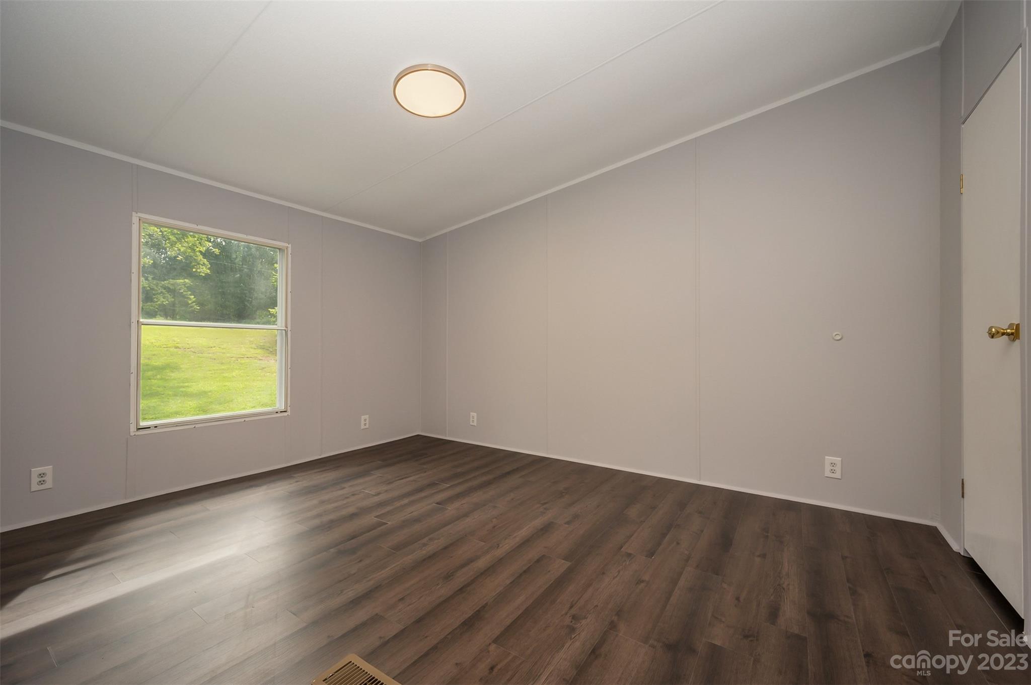 481 Brooks Road Bostic, NC 28018 - Photo 17 of 28 an empty room with wooden floor and windows