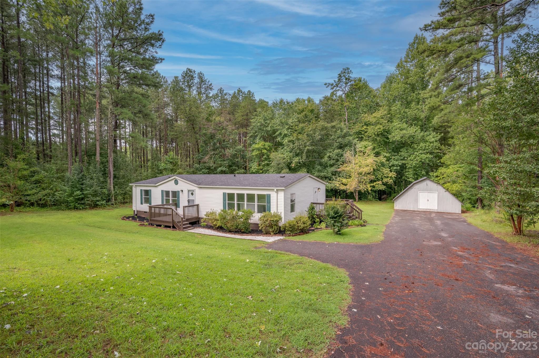 481 Brooks Road Bostic, NC 28018 - Photo 2 of 28 a view of a house with backyard and trees