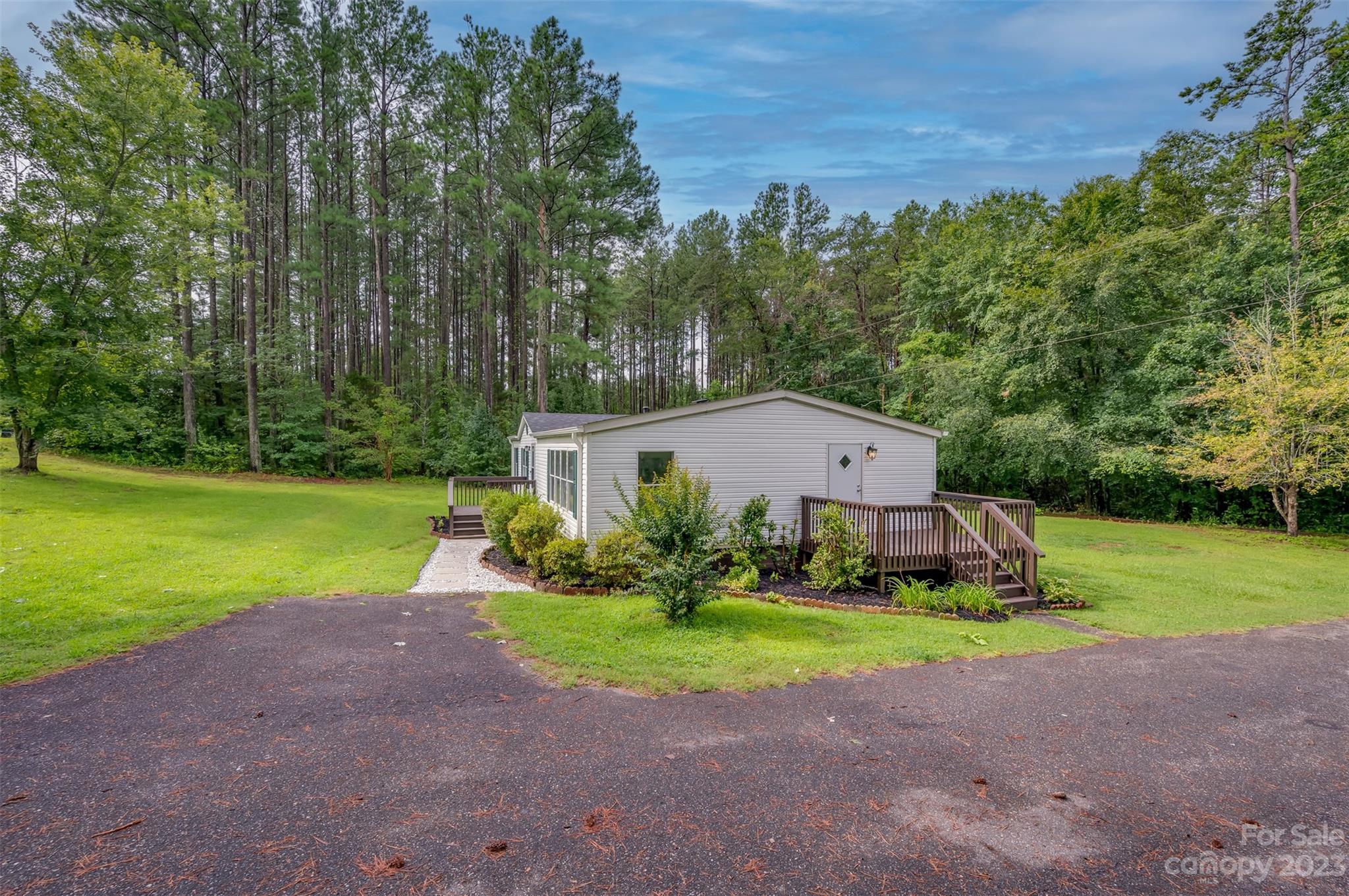 481 Brooks Road Bostic, NC 28018 - Photo 24 of 28 a view of a house with a big yard and large trees