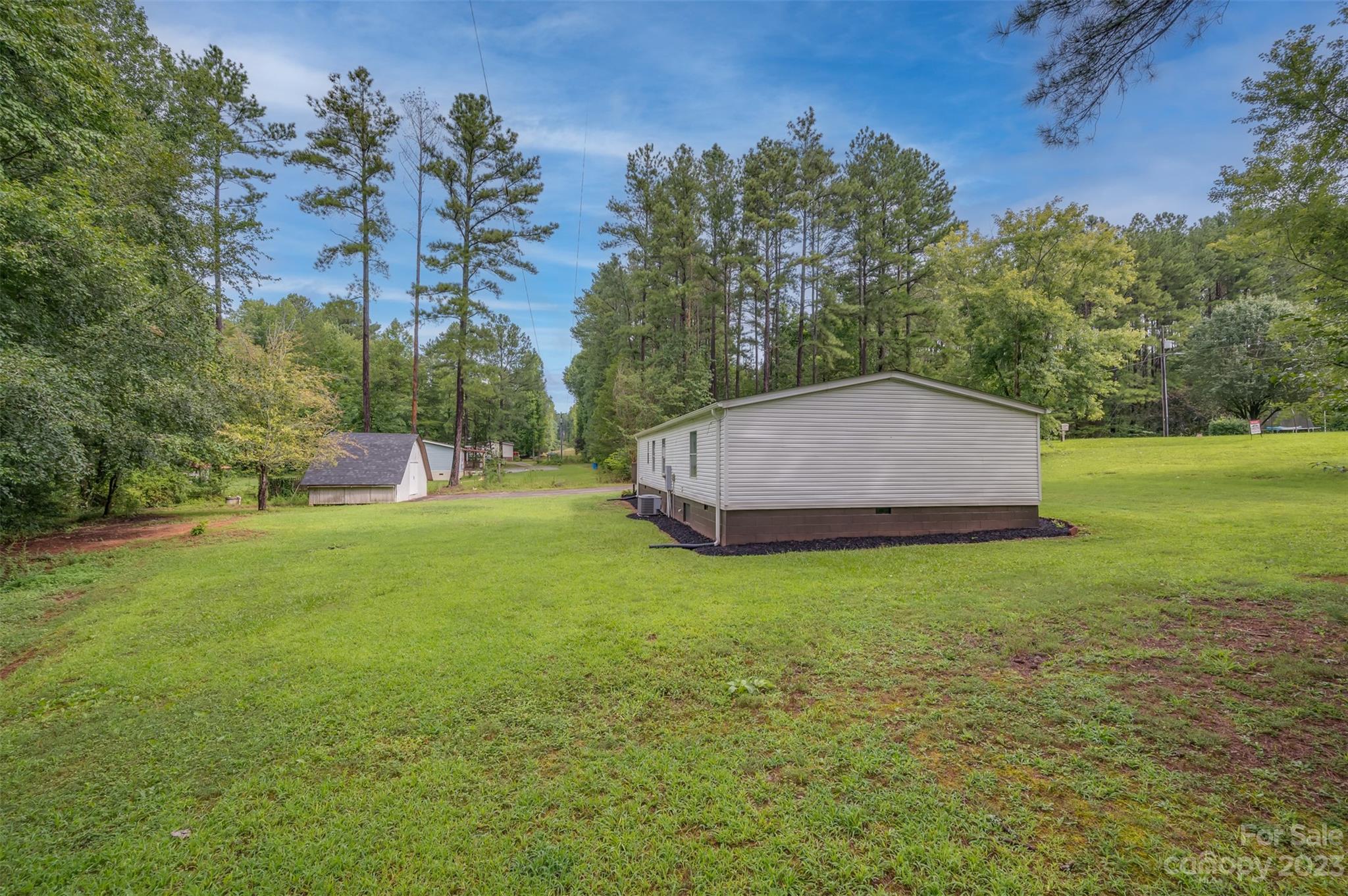 481 Brooks Road Bostic, NC 28018 - Photo 26 of 28 a backyard of a house with lots of green space