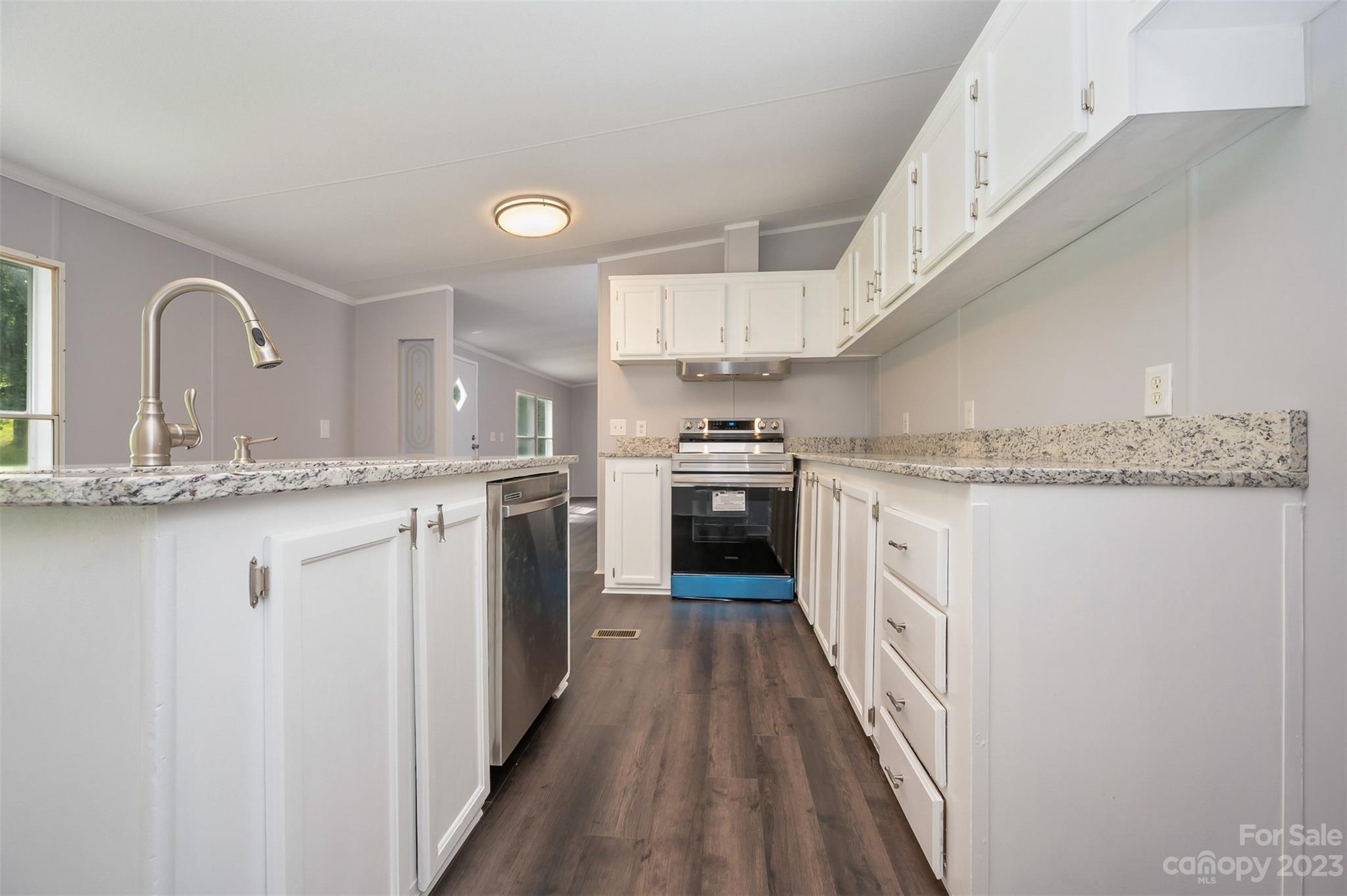 481 Brooks Road Bostic, NC 28018 - Photo 5 of 28 a kitchen with granite countertop a sink a counter top space stainless steel appliances and cabinets