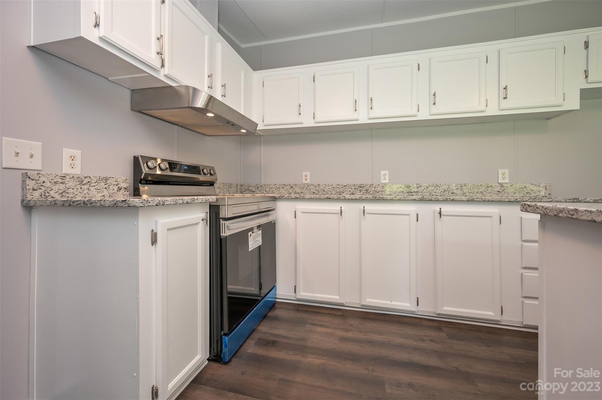 481 Brooks Road Bostic, NC 28018 - Photo 8 of 28 a kitchen with stainless steel appliances granite countertop a stove a sink and white cabinets