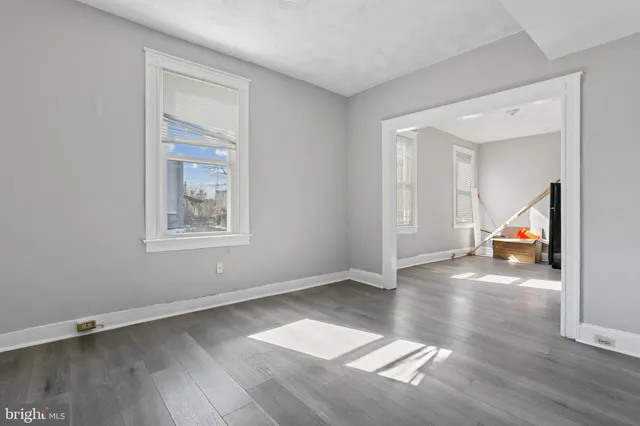 a view of empty room with wooden floor