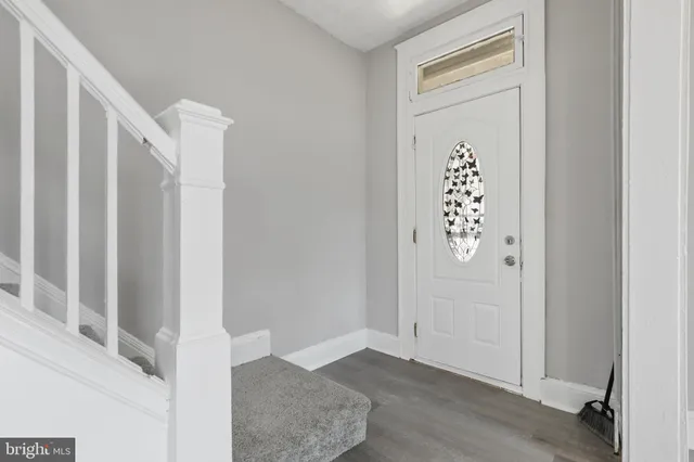 a view of an entryway with wooden floor