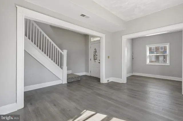 a view of an entryway with wooden floor and stairs