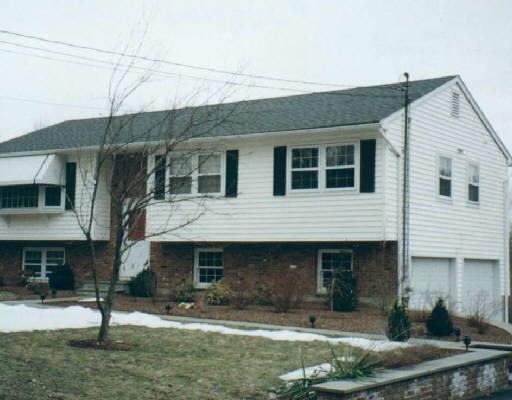 125 Briar Ridge Road Danbury, CT 06810 - Photo 1 of 1 a front view of a house with garden